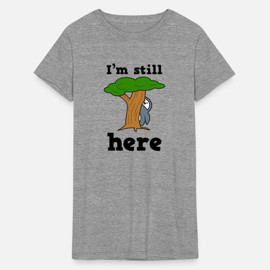 i'm still here penguin hiding behind a tree